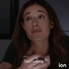 Explain+Yourself+Chicago+Pd+GIF+by+ION.gif A woman with long brown hair raises her eyebrows and speaks in a dim room, captioned 'Start talking.'