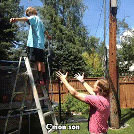 A man in a pink shirt catches a boy falling from a ladder, saying 'Rule number one, never trust anybody.'