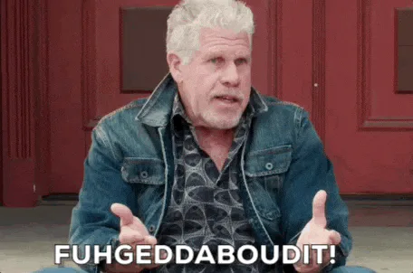 A gray haired man in a denim jacket gestures and says 'Fuhgeddaboudit!'