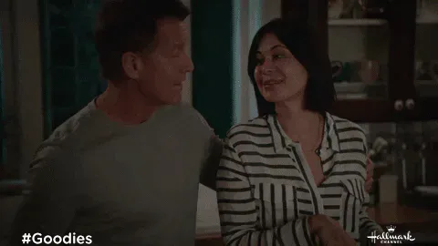 Loving+True+Love+GIF+by+Hallmark+Channel.gif A couple embraces warmly in a dim hallway, both with their eyes closed.