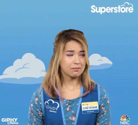 Animated reaction GIF of a sad-looking supermarket worker in a blue uniform with a Cheyenne name badge, against a cloudy blue background.