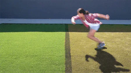 grass-is-always-greener.gif A woman sprinting across a lawn where the grass changes from dry brown to lush green.
