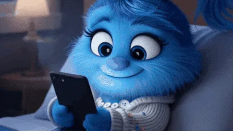 Happy+In+Love+GIF+by+The+Fuzzlets.gif A blue furry cartoon character lies in bed smiling while looking at a phone, then closes its eyes.