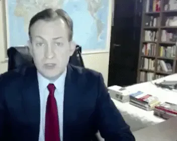 259e0d22-4b30-422f-cefc-f53d110e82c7.gif A man being interviewed on camera keeps a straight face as a small child in yellow dances into the room behind him.