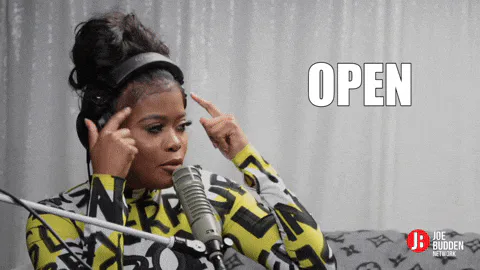 A woman with headphones points to her head at a podcast microphone, captioned 'Open your mind.'