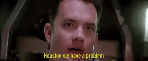 A man wearing a headset looks alarmed and says 'Houston, we have a problem.'