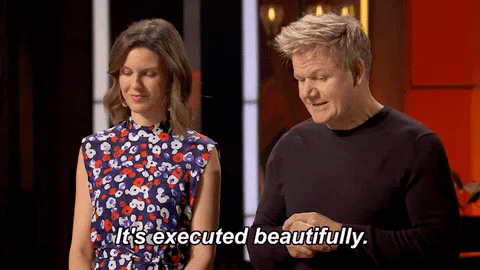 A man and a woman on a cooking show react as text reads 'It's executed beautifully.'