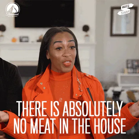 Vegan+Veggies+GIF+by+Paramount+Network.gif A woman in an orange jacket gestures animatedly in a living room and says 'There is absolutely no meat in the house.'