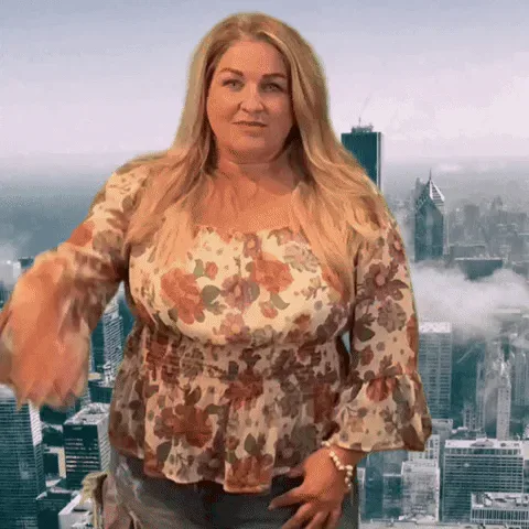 gif.gif A woman with long blond hair shields her eyes and scans a city skyline as if searching for someone.