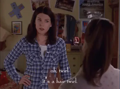 A woman says 'Oh, twirl, it's a hair twirl' to someone with their back turned.