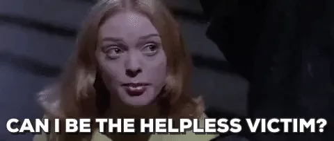 A woman with tousled blond hair asks sarcastically, 'Can I be the helpless victim?'