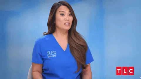 Give+Up+GIF+by+TLC+Europe.gif A woman in blue scrubs throws white tissue paper into the air in a TLC skincare segment.