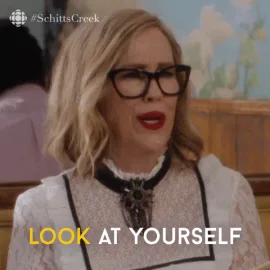 Schitts+Creek+Comedy+GIF+by+CBC.gif A woman in black cat-eye glasses and red lipstick says 'Look at yourself.'