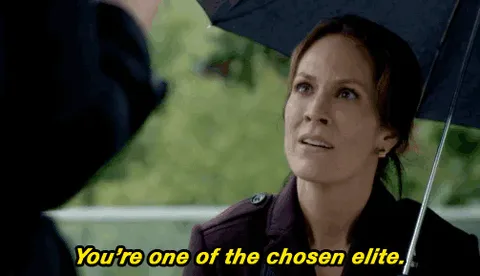 elite+fox+tv+GIF+by+The+X-Files.gif A woman under a black umbrella looks up and says 'You're one of the chosen elite.'