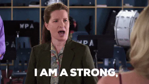 A woman in an office setting declares 'I am a strong, independent woman.'
