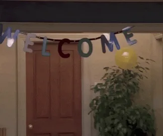 Apps 2026 stitch A person walks beneath a doorway banner that reads 'Welcome.'