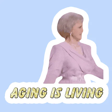 A sticker of an older woman in a mauve dress laughing, captioned 'Aging is Living.'