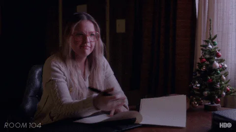 A woman at a desk beside a Christmas tree says 'Let's just agree to disagree.'