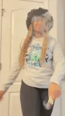 Oh+No+Wow+GIF+by+Coins+And+Connections.gif A woman with long braids in a gray sweatshirt tosses a puff of powder while standing by a door.