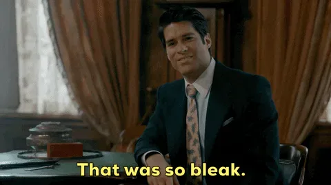 Ghosts+Thats+Depressing+GIF+by+CBS.gif A man in a suit and tie smiles at a desk, captioned 'That was so bleak.'