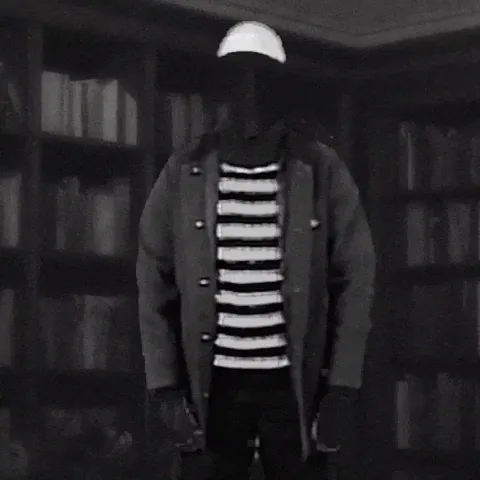 A faceless figure in a beanie, coat and striped shirt fades away as text asks 'What am I? Invisible?!'
