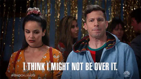 melissa+fumero+jake+peralta+GIF+by+Brooklyn+Nine-Nine.gif A man and woman stand together at a party and he says 'I think I might not be over it.'