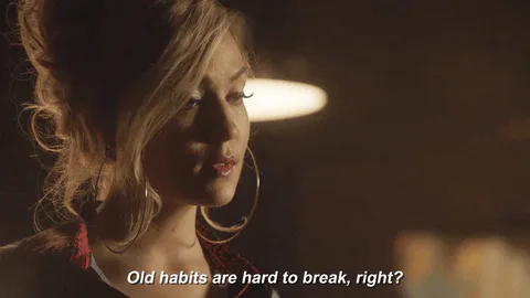 A woman with large hoop earrings says 'Old habits are hard to break, right?'