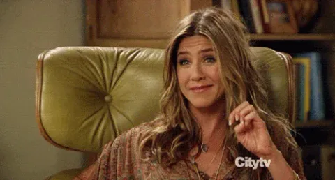 Jennifer+Aniston+Reaction+GIF.gif A woman with long blond hair in a green armchair squeezes her eyes shut and pumps her fist.