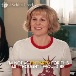 Surprised+Schitts+Creek+GIF+by+CBC.gif A woman in a red-collar shirt smiles as on-screen text reads 'I'm not as prepared for this as I thought I would be.'