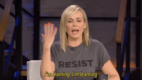 School+Education+GIF+by+Chelsea+Handler.gif A blonde woman in a shirt reading 'Resist' raises her hands and says 'I'm learning, I'm learning.'