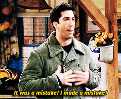 A man in a green corduroy jacket gestures while saying 'It was a mistake! I made a mistake!'