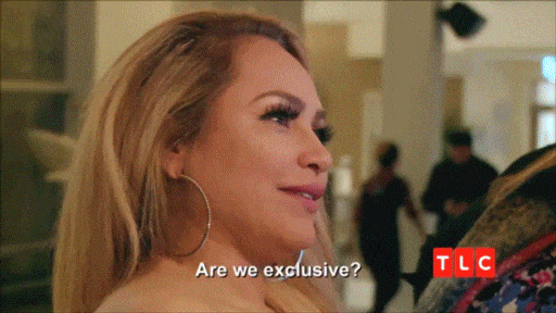 A woman at a bar asks, "Are we exclusive?" The man replies, "Is that an American thing?"