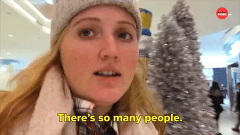 Black+Friday+Shopping+GIF+by+BuzzFeed.gif A woman in a beanie says 'There's so many people' while walking through a crowded mall.