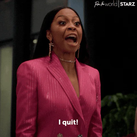 A woman in a pink blazer looks shocked, then smirks, and says 'I quit!' in a scene from Run the World.