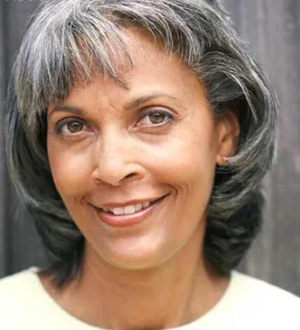Screenshot+2024-06-25+085505.png Smiling woman with gray hair and neutral background