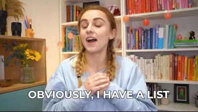 Nerd+Lists+GIF+by+HannahWitton.gif A woman with braided hair gestures in front of a bookshelf and says 'Obviously, I have a list.'