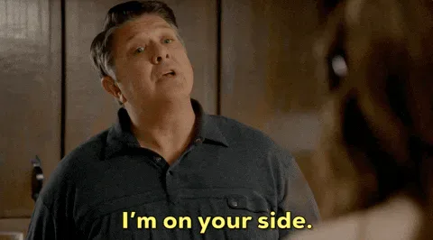 Encouraging+Lance+Barber+GIF+by+CBS.gif A man in a dark polo shirt talks with his hands and says 'I'm on your side.'