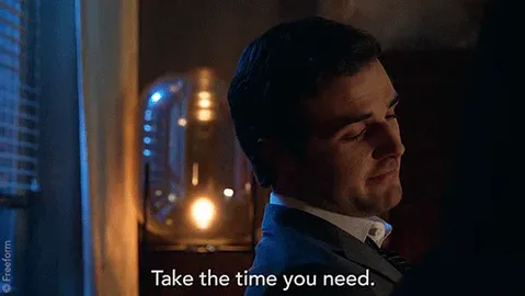 The+Fosters+Waiting+GIF+by+Good+Trouble.gif A man in a suit stands beside a glowing lamp at night and says 'Take the time you need.'