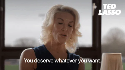 A blonde woman gestures while speaking and says 'You deserve whatever you want.'