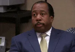 Blinking+The+Office+GIF.gif A man in a navy suit and gold tie gives a deadpan look before slowly closing his eyes.