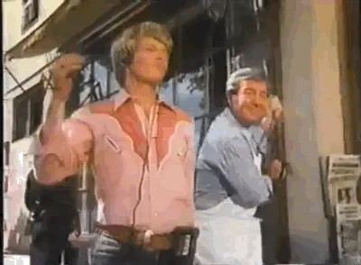 retro+peanut+butter+GIF.gif Two men and a woman react with exaggerated shouting near a tub of peanut butter outdoors.