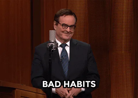 Bad+Habits+Oops+GIF+by+The+Tonight+Show+Starring+Jimmy+Fallon.gif A man points to his cheek and says 'Bad habits' at a microphone.