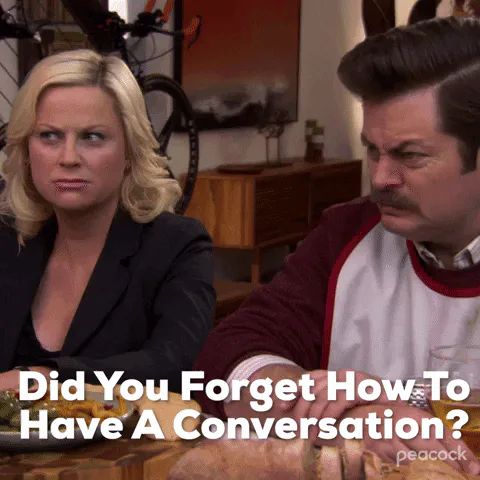 A man and woman react with concern at a table as on-screen text asks 'Did you forget how to have a conversation?'