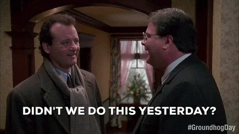 Two men in coats stand in a foyer as one asks 'Didn't we do this yesterday?'