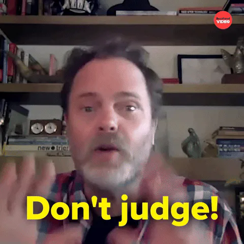 A man in a plaid shirt raises his hand and says, 'Don't judge!'