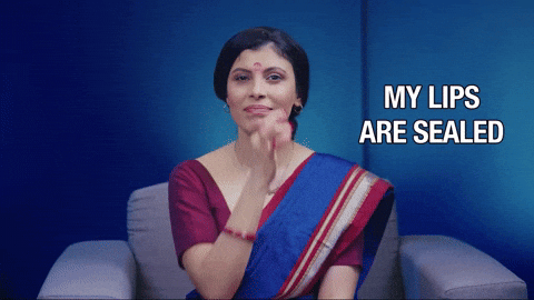 A woman in a sari presses her fingers to her lips as if sealing them, beside the words “My lips are sealed.”