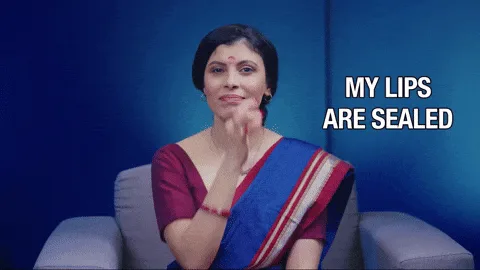 oct29-aunty-vigil.gif A woman in a sari presses her fingers to her lips as if sealing them, beside the words “My lips are sealed.”
