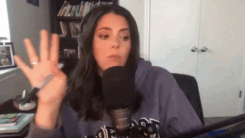 Mind+Your+Own+Business+Whatever+GIF+by+Rooster+Teeth+(1).gif A woman with long dark hair gestures at a podcast microphone and says 'Well, hey, you know, to each their own.'