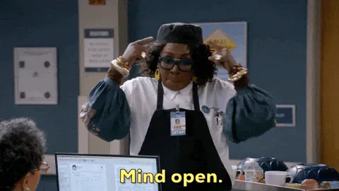 Open+Mind+Comedy+GIF+by+CBS.gif A woman in a black cap and apron raises her arms and points while talking and says 'Mind open.'
