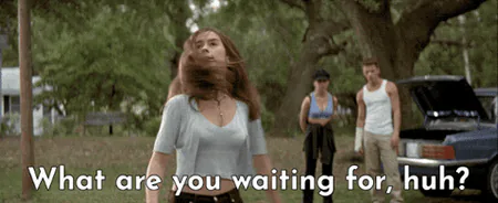 A young woman throws her arms wide and shouts in a grassy yard, two people and a parked car behind her, captioned "What are you waiting for, huh?"